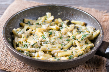 Cooked green beans in sour cream in frying pan
