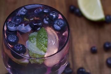 a small glass of a cocktail cool bilberry drink with berries