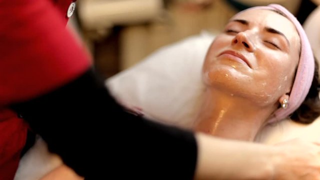beautician clears the face of the girl in the beauty salon. Facial Skin Care