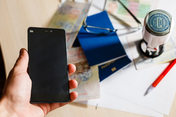 Hands working on digital device network graphic overlay