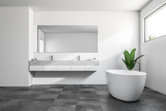 White bathroom interior, tub and double sink