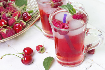 summer red cool berry drink with ice in glasses