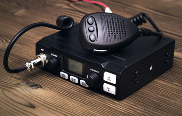 cb Radio transmitter isolated on wooden table background.