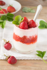 Strawberry yogurt on old wooden background