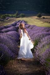 Happy woman in a white dress in a lavender field