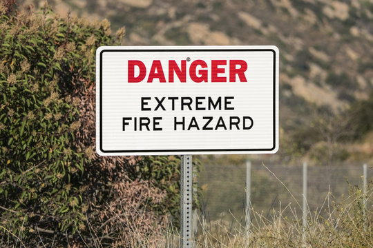 Danger extreme fire hazard sign in dry brush mountain canyon.  