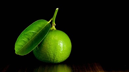 green fresh lemons on wood table - background