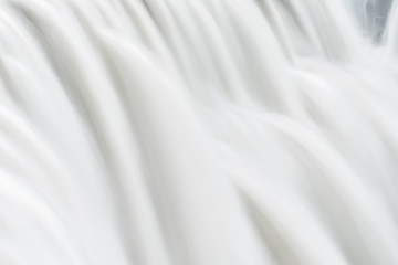 Fototapeta na wymiar Iceland Dettifoss waterfall, largest greatest volume in Europe closeup, gray grey water, abstract closeup pattern, smooth long exposure water