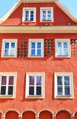 Old town building with bright orange decorative facade in poznan poland.