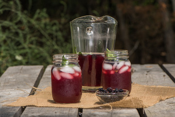 Glasses and pitcher of blackberry iced tea