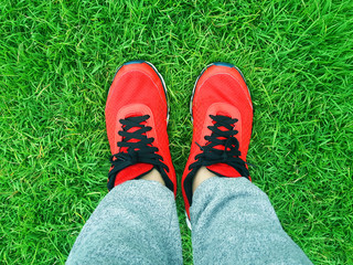 red sneakers on a background of green grass