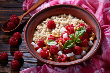 oatmeal porridge in a clay bowl, close-up