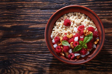 oatmeal porridge in a clay bowl, close-up