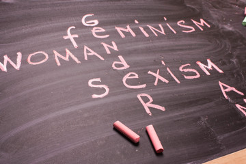 Fototapeta premium Words gender, sexism, feminism written in pink chalk