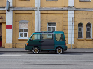 A small minibus is standing on the street