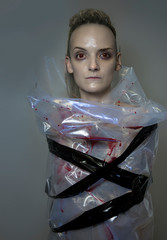 A vampire Portrait.  Hunting for a Vampire. Model's Face with pale skin and and fangs.