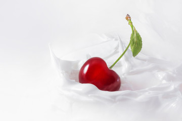 Sweet cherry in yogurt. Close-up milk or cheese dessert with cherries.