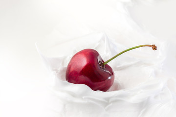 Sweet cherry in yogurt. Close-up milk or cheese dessert with cherries.