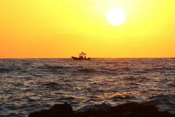 A small sea boat at sunset 
