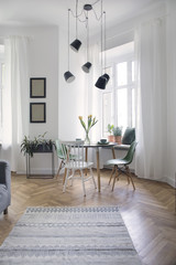 Modern interior of living room with family table and lot of plants. White walls with mock up...