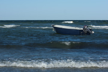 Fototapeta na wymiar Boat in baltic sea at stormy day in summer in germany