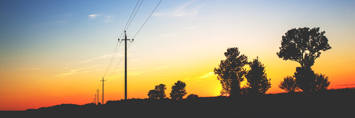 evening landscape with a golden sunset over a summer field, toned, panorama