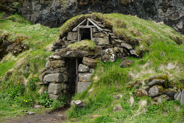 Old huts with green roofs in the rocks in DRANGSHLID