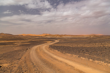 Fototapeta na wymiar Empty road in the sahara desert