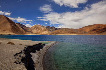 Fototapeta na wymiar Pangong Tso - Pangong Lake, located near the border between India and Tibet - Holy beautiful pure blue lake, exotic landscape in Ladakh India. High Altitude Lakes of the world, above 4000 meters