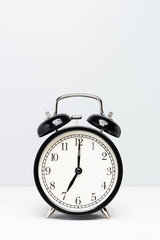 A black clock isolated on light color background.