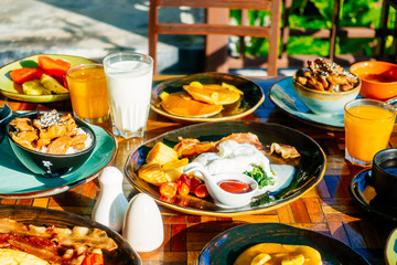 Healthy breakfast set with egg bacon pancakes orange juice milk bread and coffee