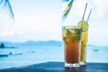 Ice mojito drinking glass with tropical sea ocean