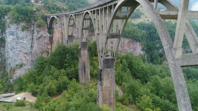 Ascending drone footage of impressive Durdevica Tara bridge, built in the 1930s in the Kingdom of Yugoslavia, in today's Montenegro