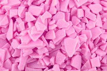 Obraz premium Candy background, copy space. Closeup of pile pastel chocolate candies. Candy texture. Food pattern. Sweets background. Pink abstract background. Top view, flat lay