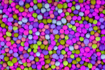 Colorful candies background, copy space. Nuts in multi-colored glaze dragee. Sweet candies spreading pastry decoration. Pile of colorful coated candy. Sweets  texture, pattern. Top view, flat lay