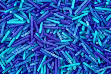 Blue candy background, copy space. Closeup of pile pastel candies. Candy texture. Candy pattern. Sweets background. Abstract background. Top view, flat lay