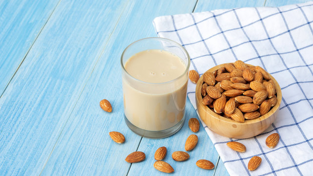 Almond milk on a blue wooden table.