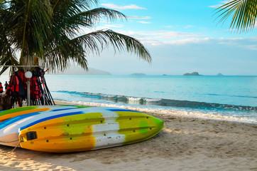 Colored canoes dry on the seashore. Kayaks in the sand are waiting for tourists.