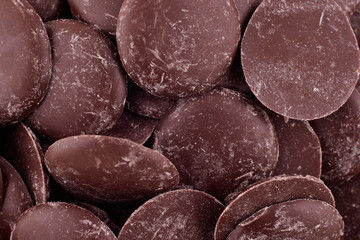 Candy dark chocolate background, copy space. Closeup of pile chocolate candies. Candy texture. Candy pattern. Sweets background. Abstract background. Top view, flat lay