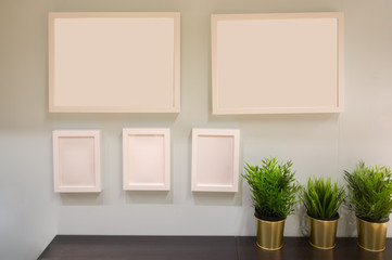 Five picture frames arranged on a wall with copy space