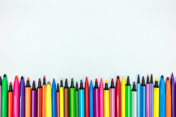elementary school supply. set of various colorful markers on white desk background, flat view