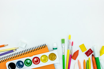 variety of school stationary and tools on white desk background with copy space, flat view