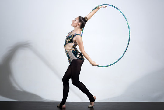 woman working out with hoola hoop in studio.