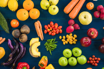 Flat lay of fresh  fruits and vegetables for background, Different fruits and vegetables for eating healthy, Top view colorful fruits and vegetables on blue plank