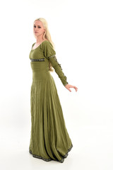 Fototapeta premium full length portrait of a blonde girl wearing green medieval gown, stand pose, isolated on white studio background.