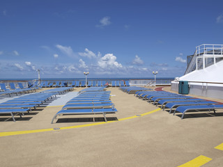 Woman tanning alone on cruise ship deck wide angle