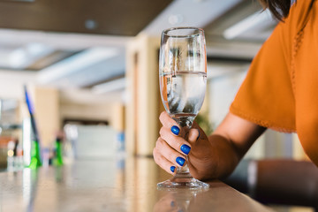 Hand holds a glass of water