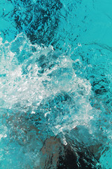 Water splash from swimmer swims in the pool
