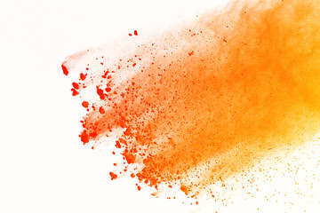 abstract orange powder splashed on white background. Colorful powder explosion isolte background....