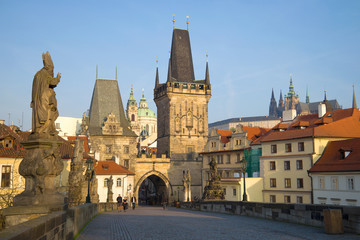 Fototapeta na wymiar View of the Western bridge towers of Karlov Bridge in the April morning. Prague, Czech Republic